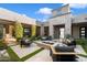 Modern patio area with a fire pit and comfortable lounge seating with outdoor tv at 11946 E Cavedale Dr, Scottsdale, AZ 85262