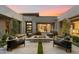 Modern patio area with a fire pit and comfortable lounge seating during sunset at 11946 E Cavedale Dr, Scottsdale, AZ 85262