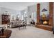 Living room with a brick fireplace and comfy furniture at 14799 W Devlin Dr, Goodyear, AZ 85395