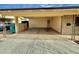 Covered carport with brick facade and ample parking space at 517 N Fraser Dr, Mesa, AZ 85203