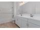 A stylish bathroom features double sinks and a shower-tub combo at 17594 W Blue Sky Dr, Surprise, AZ 85387