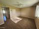 Neutral bedroom featuring ceiling fan, carpet floors and a large window at 18001 N 99Th Dr, Sun City, AZ 85373
