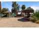 Tropical backyard oasis featuring tiki huts, lush landscaping, and brick paver patio at 848 S Revolta Cir, Mesa, AZ 85208