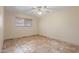 Inviting bedroom with ceiling fan, window, and unique stone tile flooring at 848 S Revolta Cir, Mesa, AZ 85208