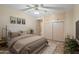 Cozy bedroom featuring neutral tones, ceiling fan, and built-in closet space for optimal storage at 848 S Revolta Cir, Mesa, AZ 85208