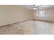 Neutral bedroom with tile flooring, a ceiling fan, and a large window at 848 S Revolta Cir, Mesa, AZ 85208
