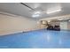 Expansive garage with blue floors, storage, ceiling fans, and room for multiple vehicles at 848 S Revolta Cir, Mesa, AZ 85208