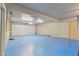 Spacious garage with blue-painted floor, garage door, and access door at 848 S Revolta Cir, Mesa, AZ 85208
