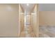 Hallway featuring travertine floors and neutral paint leading to bedrooms and living spaces at 848 S Revolta Cir, Mesa, AZ 85208