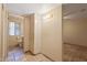 Hallway leads to well-lit bathroom with ample storage space and bright lighting at 848 S Revolta Cir, Mesa, AZ 85208