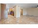 Open floor plan featuring a spacious living room with travertine tile next to the kitchen at 848 S Revolta Cir, Mesa, AZ 85208