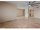 Spacious living room with tiled floors and a modern ceiling fan at 848 S Revolta Cir, Mesa, AZ 85208