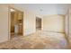 Bright living room featuring travertine floors, neutral walls, and views into the laundry room and additional living space at 848 S Revolta Cir, Mesa, AZ 85208