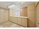 Spacious storage room with ample cabinet space, pegboard, and neutral color palette at 848 S Revolta Cir, Mesa, AZ 85208