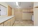 Generous storage room with abundant cabinets, countertop space, and travertine flooring at 848 S Revolta Cir, Mesa, AZ 85208