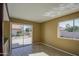 View of backyard from dining room with sliding glass doors and wood-look floors at 10437 E Chestnut Dr, Sun Lakes, AZ 85248