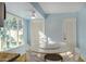 Small breakfast area with a round table and white chairs at 6511 E Presidio Rd, Scottsdale, AZ 85254