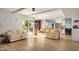 Living room with light flooring and a view into kitchen and pool at 6511 E Presidio Rd, Scottsdale, AZ 85254