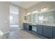 Bright bathroom with double vanity and view into bedroom at 16367 W Morning Glory St, Goodyear, AZ 85338