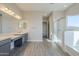 Elegant bathroom with double vanity, soaking tub, and separate shower at 16367 W Morning Glory St, Goodyear, AZ 85338