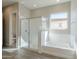 Spa-like bathroom featuring a soaking tub and a walk-in shower at 16367 W Morning Glory St, Goodyear, AZ 85338