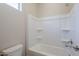 Clean bathroom with a shower/tub combo and built-in shelves at 16367 W Morning Glory St, Goodyear, AZ 85338