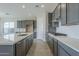 Modern kitchen with gray cabinets, quartz countertops and stainless steel appliances at 16367 W Morning Glory St, Goodyear, AZ 85338