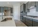 Modern kitchen with stainless steel sink and gray cabinets at 16367 W Morning Glory St, Goodyear, AZ 85338