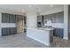 Modern kitchen with gray cabinets and quartz countertops at 16367 W Morning Glory St, Goodyear, AZ 85338