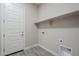 Bright laundry room with built-in shelving and tile floor at 16367 W Morning Glory St, Goodyear, AZ 85338