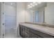 Bathroom boasts granite countertop, dark brown vanity, and shower/tub combo at 16417 W Desert Mirage Dr, Surprise, AZ 85388