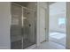 Shower with glass enclosure and subway tile surround at 16417 W Desert Mirage Dr, Surprise, AZ 85388