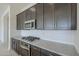 Modern kitchen with granite countertops and stainless steel appliances at 16417 W Desert Mirage Dr, Surprise, AZ 85388