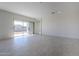 Spacious living room with tile floors and access to backyard at 16417 W Desert Mirage Dr, Surprise, AZ 85388