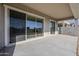 Covered patio with sliding glass doors leading to backyard at 16417 W Desert Mirage Dr, Surprise, AZ 85388