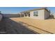 Large backyard with block wall and dirt at 16425 W Desert Mirage Dr, Surprise, AZ 85388