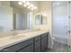 Bathroom with gray vanity, quartz countertop, and a shower/tub combo at 16425 W Desert Mirage Dr, Surprise, AZ 85388