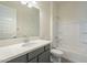 Bathroom with grey vanity, white tub, and tile flooring at 16425 W Desert Mirage Dr, Surprise, AZ 85388