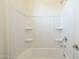 Clean bathroom with shower/tub combo and built-in shelves at 16425 W Desert Mirage Dr, Surprise, AZ 85388