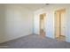 Simple bedroom with doors to other rooms and gray carpet at 16425 W Desert Mirage Dr, Surprise, AZ 85388