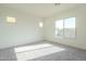 Well-lit bedroom with grey carpet and large windows at 16425 W Desert Mirage Dr, Surprise, AZ 85388