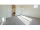 Bright bedroom with grey carpet, ensuite bathroom, and window at 16425 W Desert Mirage Dr, Surprise, AZ 85388