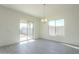 Bright dining room with sliding glass door to backyard and chandelier at 16425 W Desert Mirage Dr, Surprise, AZ 85388