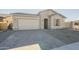 One-story home with stone accents and a two-car garage at 16425 W Desert Mirage Dr, Surprise, AZ 85388