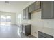 Kitchen with gray cabinets, white tile backsplash, and breakfast bar at 16425 W Desert Mirage Dr, Surprise, AZ 85388