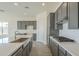 Modern kitchen with gray cabinets, white subway tile backsplash, and farmhouse sink at 16425 W Desert Mirage Dr, Surprise, AZ 85388