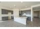 Modern kitchen with gray cabinets, white quartz countertops, and island at 16425 W Desert Mirage Dr, Surprise, AZ 85388