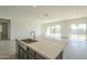 Kitchen island with farmhouse sink and large quartz countertop at 16425 W Desert Mirage Dr, Surprise, AZ 85388