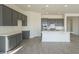 Spacious kitchen featuring gray cabinets, white quartz countertops and island at 16425 W Desert Mirage Dr, Surprise, AZ 85388