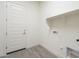 Laundry room with shelving and tile flooring at 16425 W Desert Mirage Dr, Surprise, AZ 85388